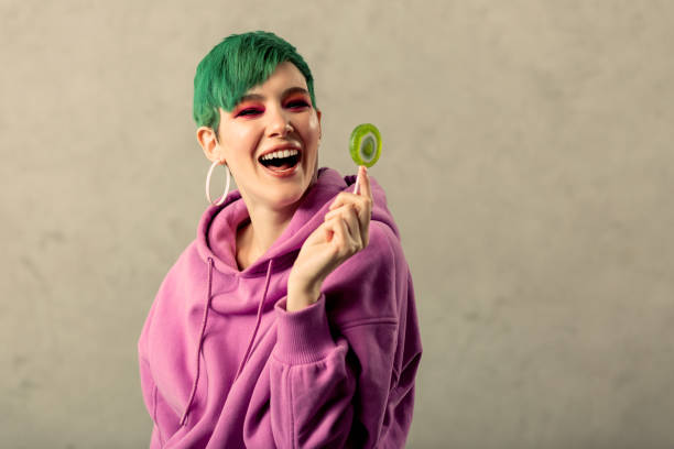 istock Joyful positive woman holding a green candy 1130746579