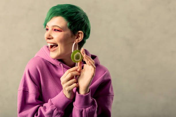 istock Nice green haired woman touching a lollipop 1130746600