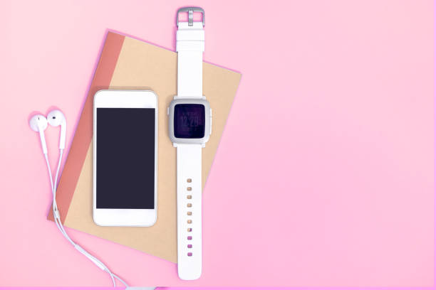 istock Empty mobile phone with smartwatch gadgets on pink copy space 1130747480