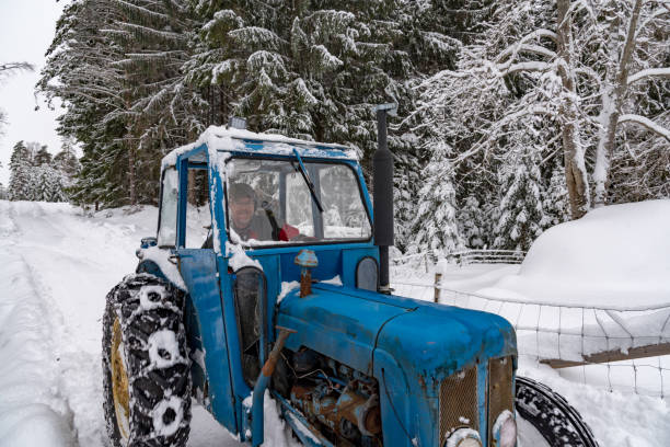 istock old blue fordson dexta tractor plowing snow 1130747951