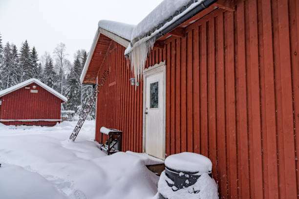 istock icicles hanging from a roof on a red cabin 1130747957