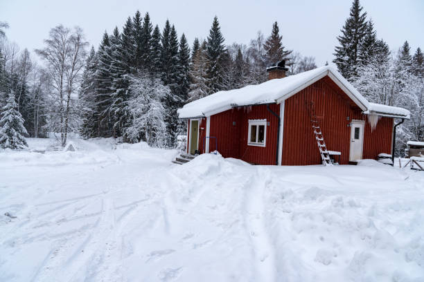 istock red cabin covered in snow in sweden 1130747958