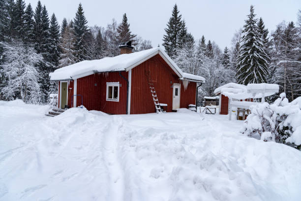 istock red cabin covered in snow in sweden 1130747960