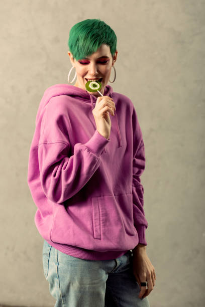 istock Nice green haired woman trying a lollipop 1130748313