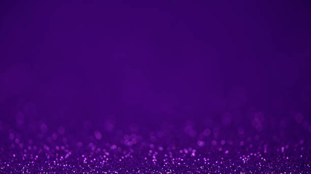 Purple glitter lights background. Defocused