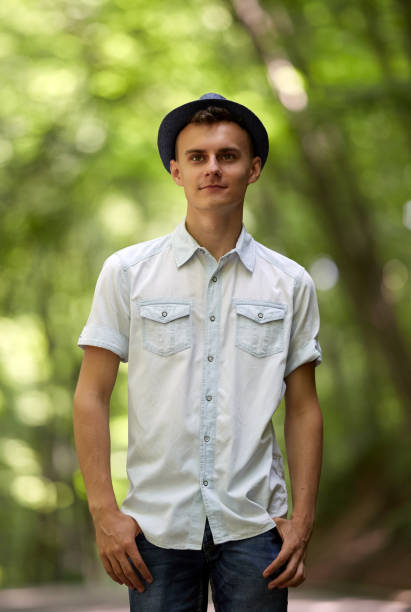 Closeup portrait of a happy handsome teenage boy outdoor in the park