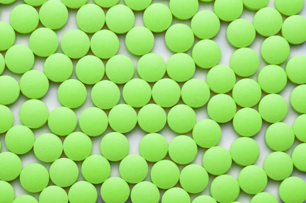 istock Small green pills on a white background close-up. 1130751862