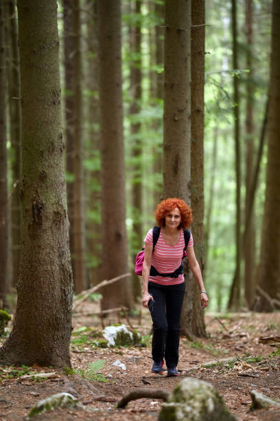 istock Woman tourist hiking with backpack 1130752066