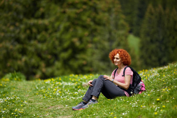 istock Woman tourist hiking with backpack 1130752072