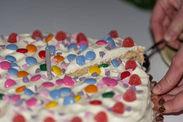 istock birthday cake with cream and lots of candy 1130754809