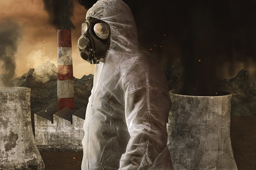 survivor with white overall and gas mask in front of incineration plant and apocalyptic environment