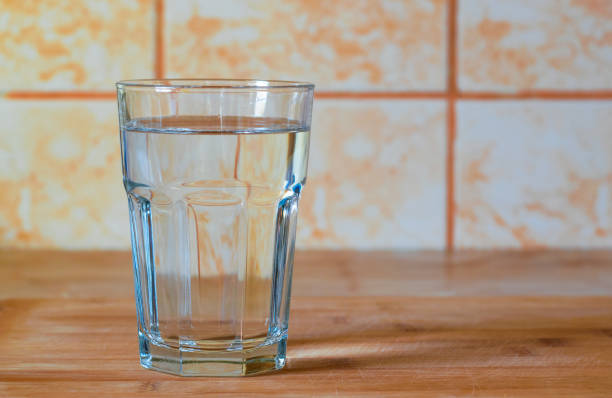 istock Glass of pure water on kitchen table 1130757169