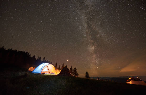 istock Night summer camping in the mountains under night starry sky 1130760244