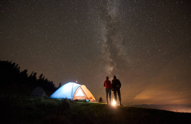istock Night summer camping in the mountains under night starry sky 1130760245