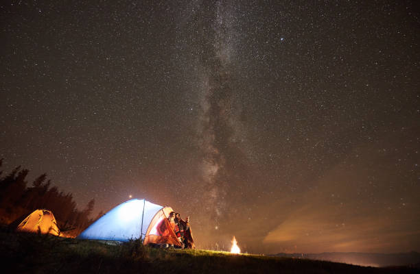 istock Night summer camping in the mountains under night starry sky 1130760258