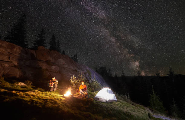 istock Night summer camping in the mountains under night starry sky 1130760259