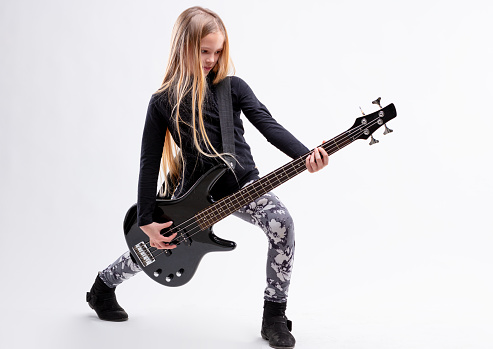 blonde long haired girl is a bass  guitar metal or hard rock player