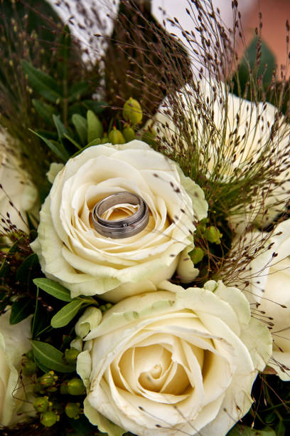 istock bride holding wedding bouquet white roses 1130760263