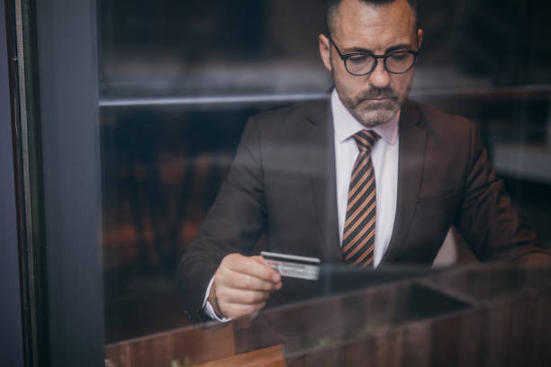 istock Senior businessman holding credit card 1130762333