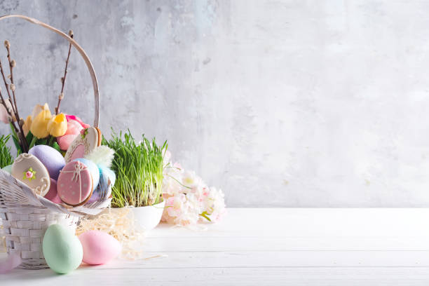 istock Easter greeting card with glazed cookies and colorful easter eggs in basket . With copy space 1130763258