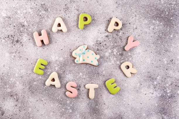 istock Happy Easter colorful lettering Happy Easter of ginger biscuits and cookies bunny on stone background. 1130763406