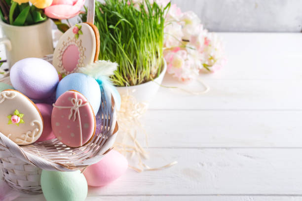 istock Easter greeting card with glazed cookies and colorful easter eggs in basket . With copy space 1130763656