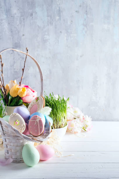 istock Easter greeting card with glazed cookies and colorful easter eggs in basket . With copy space 1130763663