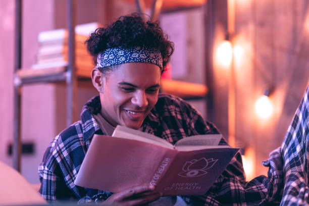 istock Boy surprisingly candidly smiling to romantic story he reading in his book. 1130763818