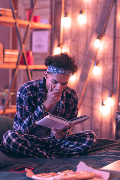 istock Interested guy reading a story and sincerely reacting to it. 1130763888