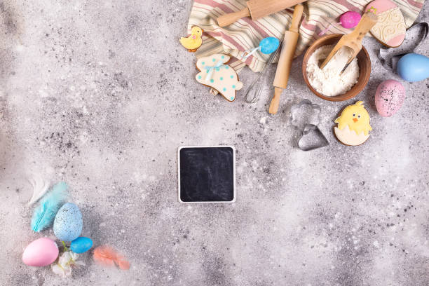 istock Baking accessories on stone background with flour, eggs and easter glazed cookies . Easter preparation or baking sweets, flat lay with copy space 1130764039