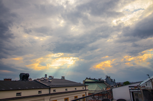 Sun rays fallen thru the cloudy sky on an old city in Krakow, Poland
