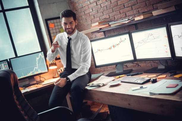 istock Young male trader at office work concept sitting drinking coffee 1130771072