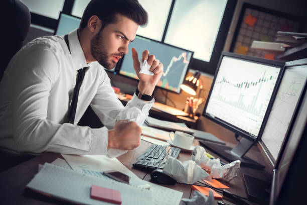 istock Young male trader at office work concept sitting crumpling paper 1130771088