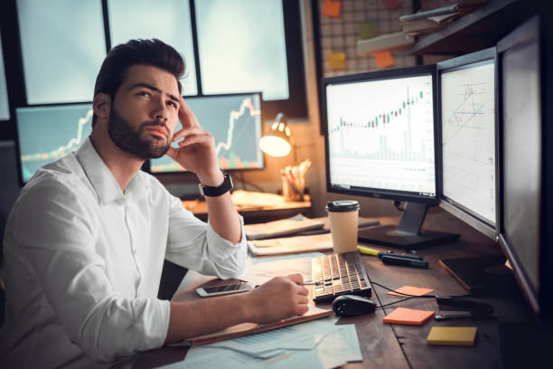 istock Businessman thinking and using computer of trading graph 1130771116