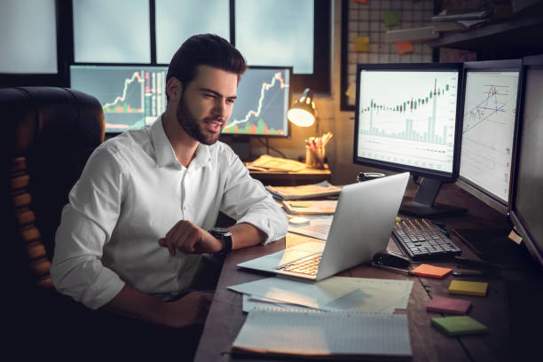 istock Young male trader at office work concept sitting looking at laptop screen 1130771122
