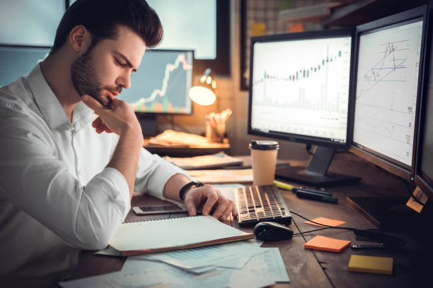 istock Young male trader at office work concept sitting browsing smartphone concentrated 1130771135