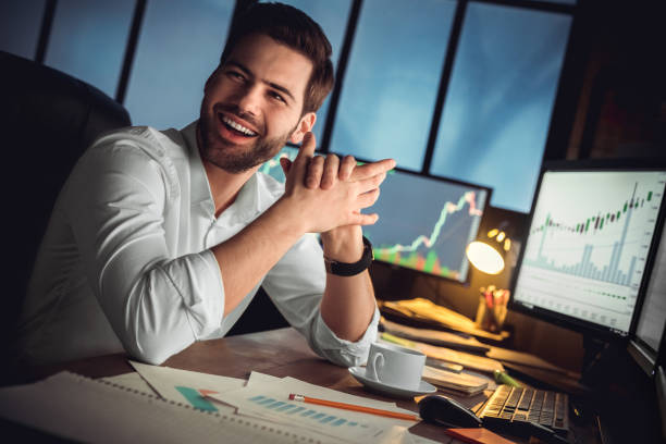 istock Young male trader at office work concept sitting looking aside cheerful 1130771143