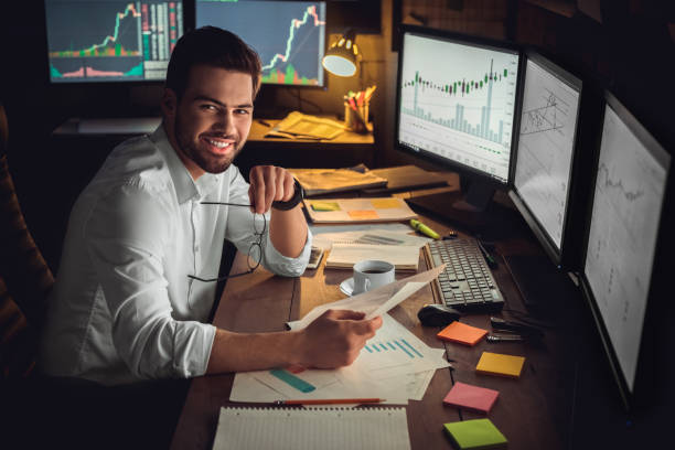 istock Young male trader at office work concept sitting holing eyeglasses and document 1130771154
