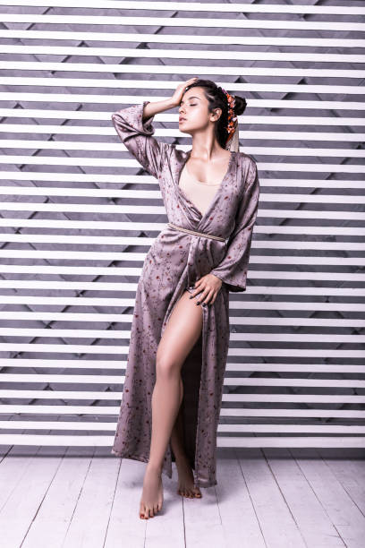 istock Nice-appealing beauteous dark-haired girl striking a pose amid studio shoot 1130771233