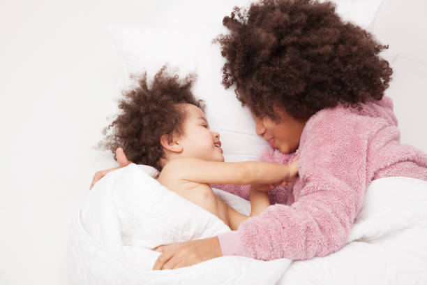 istock Two little sisters in bed 1130775168
