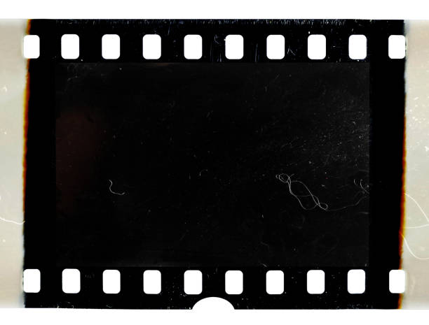 real scan of old 35mm filmstrip or photo frame with burned edges on white background real scan of old film material 35mm movie camera stock pictures, royalty-free photos & images