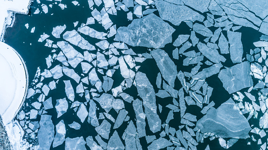 This pic show aerial view of frozen sea. Big Cracked ice floe floating on baltic sea in Helsinki finland.