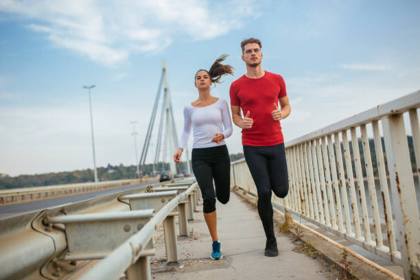 istock Two athletes jogging at the bridge 1130778791