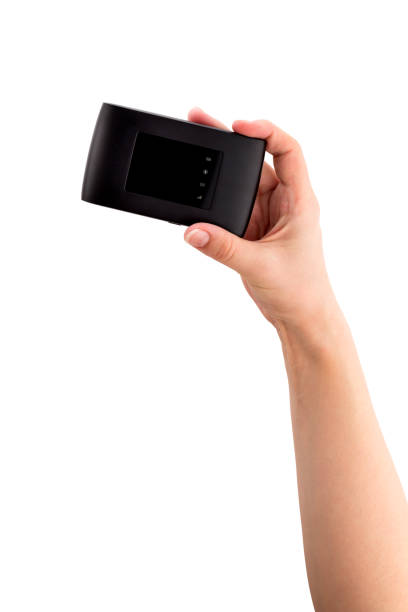 istock Portable usb router on a white background. 4g router in hand on a white background. 1130782019