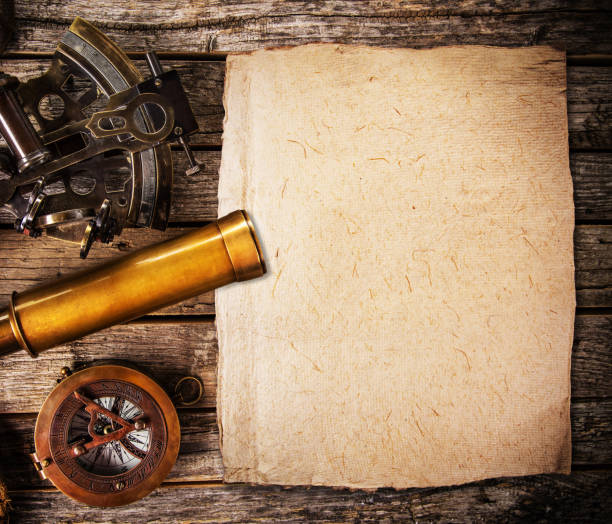 istock Old vintage navigation equipment with blank paper on wooden table. 1130782059
