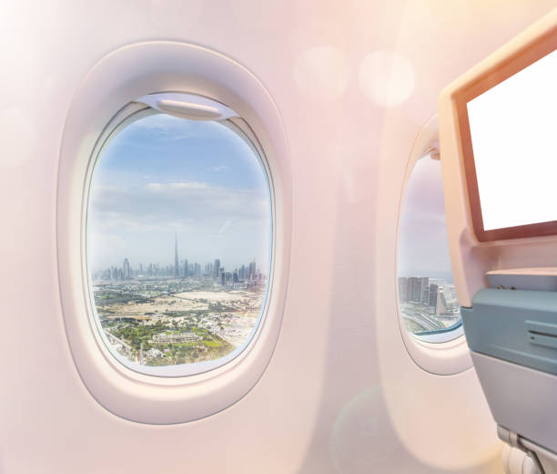 istock Airplane interior with window view of Dubai city, UAE. 1130782408