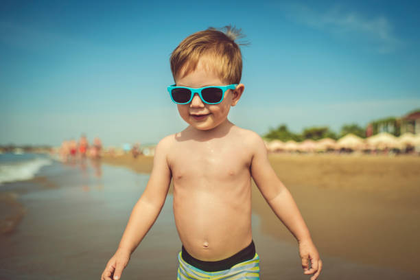Happy child walking near the sea on beach holidays