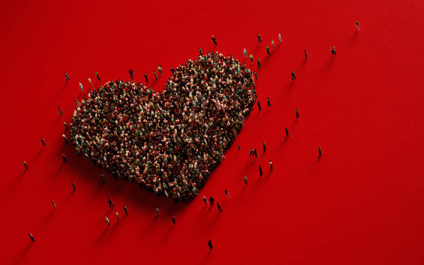 istock Human Crowd Forming A Big Heart Shape On Red Background: Love and Donation Concept 1130786658
