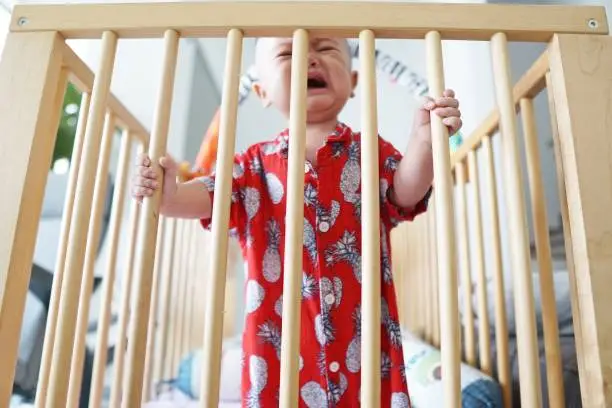 A baby boy was crying inconsolably when he was put on isolation inside his baby cot.