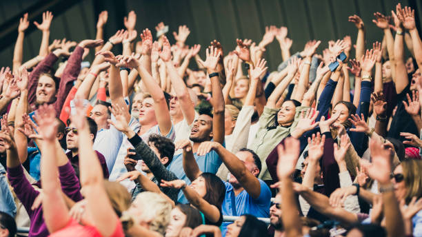 istock Crowd cheering for their team with arms raised 1130790194